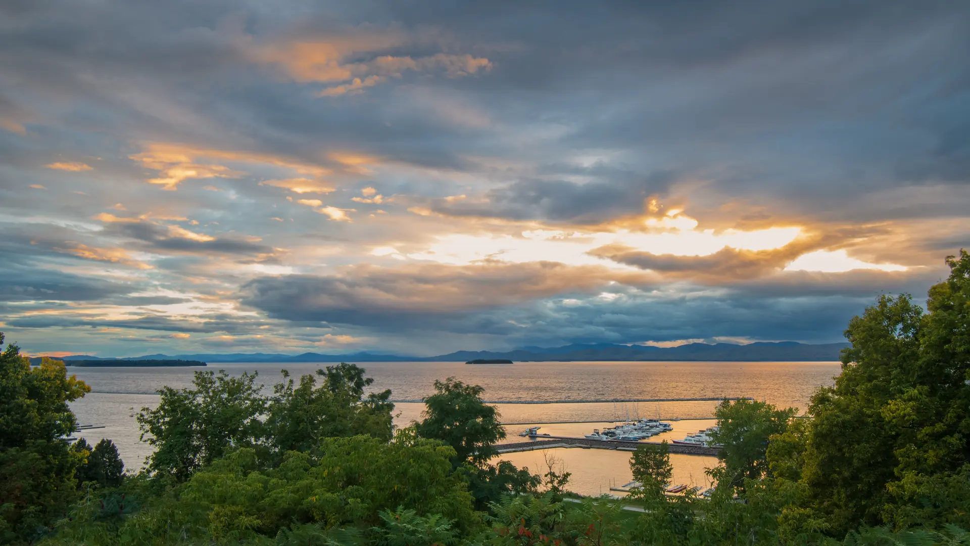 Sunset over Lake Champlain and distant mountains in Vermont