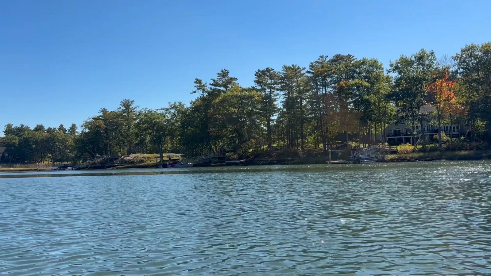 Wooded shoreline and homes viewed from Sagamore Creek at Tuckers Cove